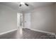 Bedroom with grey wood-look floors and access to hallway at 7704 Woodland Hills Rd, Hickory, NC 28602