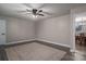 Spacious bedroom with ceiling fan, neutral walls, and view to dining area at 7704 Woodland Hills Rd, Hickory, NC 28602