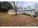 Gray siding ranch home with a large tree in the front yard and an attached garage at 7704 Woodland Hills Rd, Hickory, NC 28602