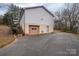 Detached garage with a brown door and paved driveway at 7704 Woodland Hills Rd, Hickory, NC 28602