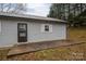 Side of house with gray siding and small patio at 7704 Woodland Hills Rd, Hickory, NC 28602