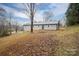 Ranch-style home with a gray exterior and fire pit at 7704 Woodland Hills Rd, Hickory, NC 28602