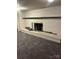 Basement with a white brick fireplace and carpeting at 904 Mascot Dr, Albemarle, NC 28001