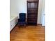 Home office featuring hardwood floors and built-in shelving at 904 Mascot Dr, Albemarle, NC 28001