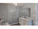 Stylish bathroom, featuring a marble vanity and soaking tub at 9175 Cox Rd, Mount Pleasant, NC 28124