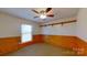 Cozy bedroom with wood paneling and wall shelves at 9175 Cox Rd, Mount Pleasant, NC 28124