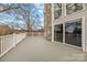 Spacious deck with white railings and stone wall at 9175 Cox Rd, Mount Pleasant, NC 28124