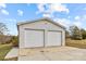 Detached two-car garage with white doors at 9175 Cox Rd, Mount Pleasant, NC 28124