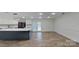 Modern kitchen with island, stainless steel appliances, and access to backyard at 9175 Cox Rd, Mount Pleasant, NC 28124