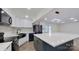 Modern kitchen with white cabinets, large island, and black appliances at 9175 Cox Rd, Mount Pleasant, NC 28124