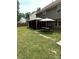 Green backyard featuring a gazebo, table, grill, and wood fence at 9624 Langston Mill Rd, Charlotte, NC 28216