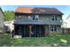 Backyard view featuring a covered and screened patio with a lawn, and a two-story house with gray siding at 9624 Langston Mill Rd, Charlotte, NC 28216