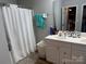 Bright bathroom featuring a double vanity with storage and a shower with a white curtain at 9624 Langston Mill Rd, Charlotte, NC 28216