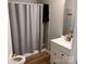 Neutral bathroom featuring a vanity with storage and a shower with a grey curtain, providing a clean and functional space at 9624 Langston Mill Rd, Charlotte, NC 28216