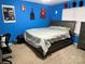 Bedroom features a gray bed, blue walls, a chair, and a dresser, offering a comfortable living space at 9624 Langston Mill Rd, Charlotte, NC 28216