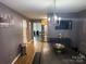 Open dining area with modern chandelier, dining table and view to the kitchen at 9624 Langston Mill Rd, Charlotte, NC 28216