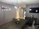 Open dining area with modern chandelier, dining table and view to the living area at 9624 Langston Mill Rd, Charlotte, NC 28216