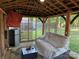 Cozy screened-in gazebo with seating, mini-fridge, and outdoor comfort at 9624 Langston Mill Rd, Charlotte, NC 28216