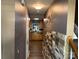 Hallway leading to the kitchen and staircase with a stone accent wall at 9624 Langston Mill Rd, Charlotte, NC 28216