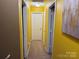 Hallway with yellow walls and neutral carpeting at 9624 Langston Mill Rd, Charlotte, NC 28216