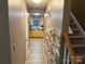 Hallway with stone accent wall and view into the kitchen at 9624 Langston Mill Rd, Charlotte, NC 28216