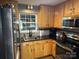 Charming kitchen featuring wood cabinets, stainless steel appliances, and granite countertops at 9624 Langston Mill Rd, Charlotte, NC 28216