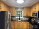 Charming kitchen featuring wood cabinets, stainless steel appliances, and granite countertops at 9624 Langston Mill Rd, Charlotte, NC 28216
