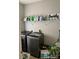 Bright laundry room includes a modern washer and dryer, storage shelving, and convenient laundry signage at 9624 Langston Mill Rd, Charlotte, NC 28216