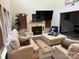 Spacious living room featuring a fireplace, large TV, and ample seating at 9624 Langston Mill Rd, Charlotte, NC 28216