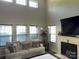 Inviting living room with vaulted ceilings, fireplace, plush furniture, and a view into the recreation room at 9624 Langston Mill Rd, Charlotte, NC 28216