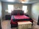 Well-lit main bedroom featuring a large bed, neutral carpet and tasteful decor at 9624 Langston Mill Rd, Charlotte, NC 28216