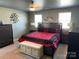 Spacious main bedroom featuring a large bed, tasteful decor, and two bright windows at 9624 Langston Mill Rd, Charlotte, NC 28216