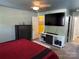 Inviting main bedroom with a large television, neutral walls, open doorway and carpeted floor at 9624 Langston Mill Rd, Charlotte, NC 28216