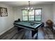 The recreation room features hardwood floors, a modern light fixture, and a pool table at 9624 Langston Mill Rd, Charlotte, NC 28216