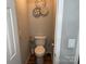 Clean toilet room featuring a modern toilet, wall decor, and fresh paint at 9624 Langston Mill Rd, Charlotte, NC 28216