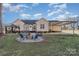 Fire pit and seating area in backyard at 101 Ingonish Dr, Gastonia, NC 28056