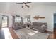 Open living room with hardwood floors, couches, and view into kitchen at 101 Ingonish Dr, Gastonia, NC 28056