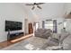 Bright living room with hardwood floors, comfy couches, and large TV at 101 Ingonish Dr, Gastonia, NC 28056