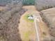 Aerial view of a farmhouse on a large lot with surrounding trees and fields at 1026 Walker Branch Rd, Lincolnton, NC 28092