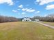 Stunning aerial view of a two-story farmhouse on a spacious lot with a detached garage at 1026 Walker Branch Rd, Lincolnton, NC 28092