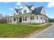 Two-story farmhouse with a large front porch, attached garage and brick accents at 1026 Walker Branch Rd, Lincolnton, NC 28092