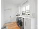 Laundry room with white cabinets, built-in sink, and matching washer and dryer at 1026 Walker Branch Rd, Lincolnton, NC 28092