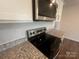 Close up of modern kitchen with stainless steel microwave and range over granite countertop at 1058 Horizon Ave, Chester, SC 29706