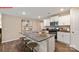 Granite kitchen island with seating, white cabinets, and hardwood floors at 1058 Horizon Ave, Chester, SC 29706