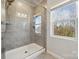 Clean bathroom with a large shower, a window overlooking trees, and modern fixtures at 1248 Thomas Knapp Pkwy, Fort Mill, SC 29715