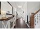 Hallway with dark hardwood floors, console table, and staircase at 1248 Thomas Knapp Pkwy, Fort Mill, SC 29715