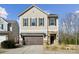 Two-story house with beige siding, brown garage door, and stone accents at 1248 Thomas Knapp Pkwy, Fort Mill, SC 29715