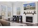 Fireplace with shiplap surround, TV above, and built-in shelves at 1248 Thomas Knapp Pkwy, Fort Mill, SC 29715