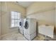 Bright laundry room, washer, dryer, and utility sink at 1257 Stacey Ln, Indian Land, SC 29707