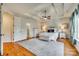 Main bedroom with hardwood floors, tray ceiling, and attached bath at 1257 Stacey Ln, Indian Land, SC 29707